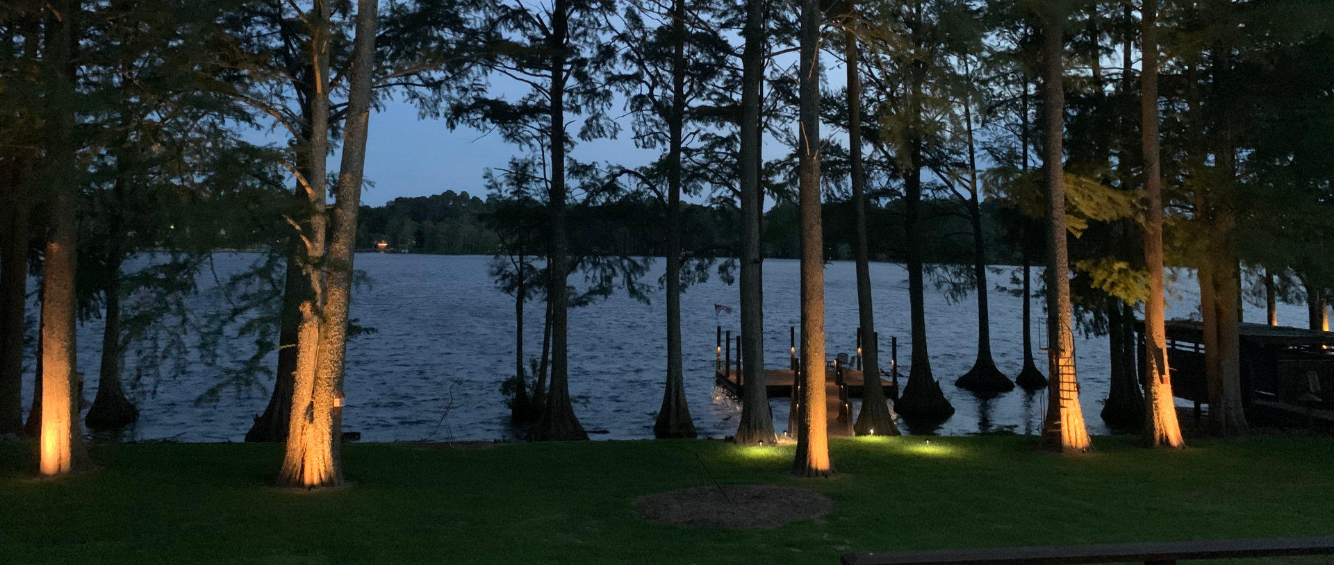 Landscape Lighting on a lake Dock at dusk.